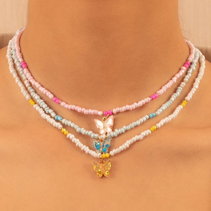 collier perles papillon NH829108