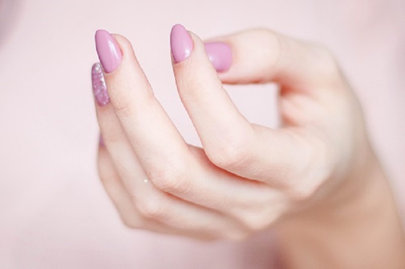 hand with pink nail polish